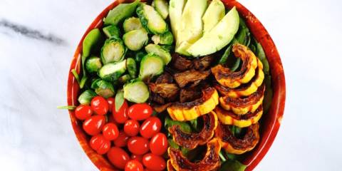 A bowl of squash salad with jackfruit bacon