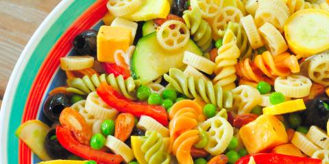 a bowl of pasta tossed with summer veggies