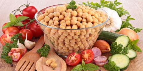 A bowl of chickpeas and salad ingredients