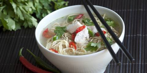 Bowl of asian chicken noodle soups with chopsticks.