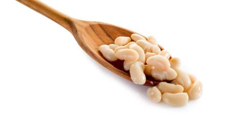 Cannellini beans on wooden spoon