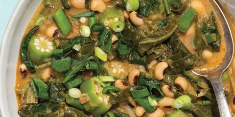 a steaming bowl of spicy gumbo loaded with greens