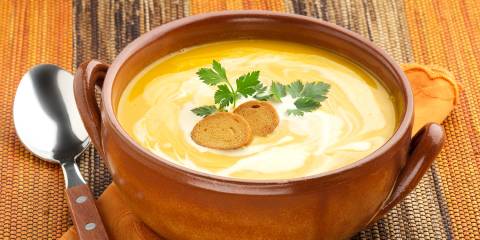 a bowl of carrot soup with a dollop of yogurt