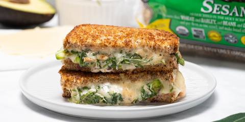 a vegan melt with arugula on golden pan-cooked toast