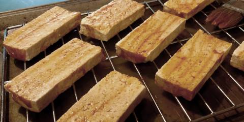slices of tofu on the grill with a little oil