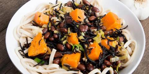 black beans and sweet potatoes on a bed of soba noodles