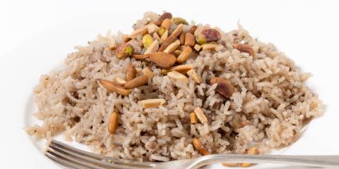 a plate of seasoned rice with almonds