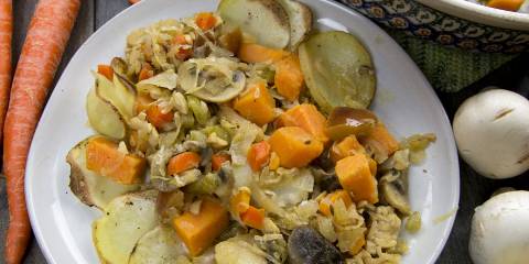 a dish of vegetables, sweet potatoes, and sauerkraut
