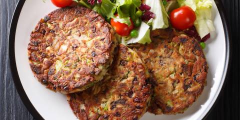 a platter of vegetarian patties with a side salad