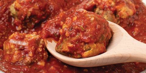 an eggplant meatball covered in red sauce