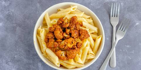 a bowl of penne with spicy roasted cauliflower on top