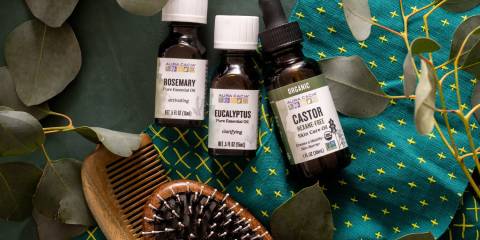 a brush, a comb, and bottles of essential oils