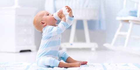A baby boy drinking formula from a bottle