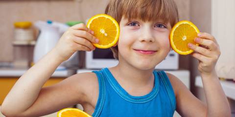 A young boy with orange slices