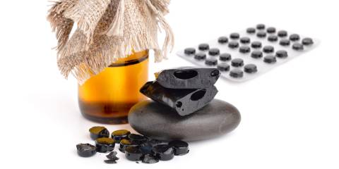 shilajit, a bottle of tincture, and tablets