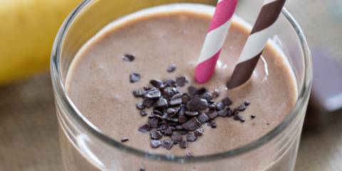 a superfood smoothie in a glass with chocolate chips