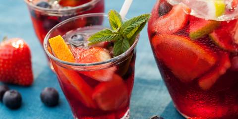a sparkling punch mocktail with cut fruit and garnish
