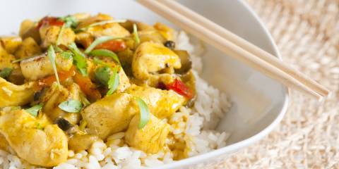 A bowl of curry chicken on jasmine rice