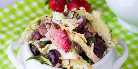 a dish of coleslaw with berries and seeds