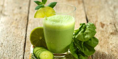 a smoothie made with cucumber, lime, and spinach
