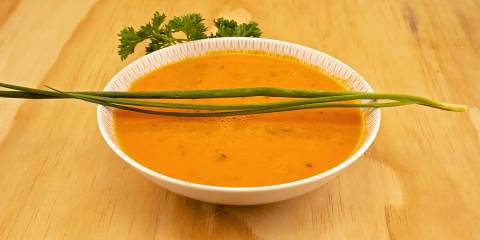 a bowl of tomato soup with fresh chives