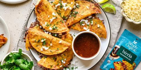 Birria Tacos on plate with dipping sauce and seasoning packet