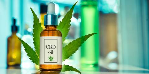 Glass bottle CBD OIL, tincture with laboratory for the production of CBD oil.