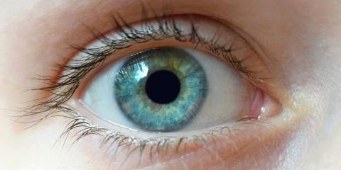A close-up of a woman's clear blue eye