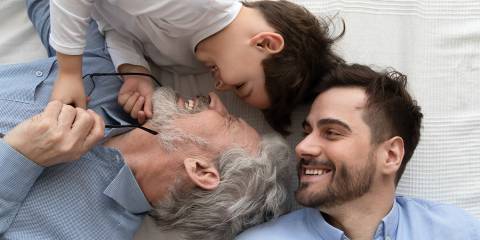 three generations of men laughing together