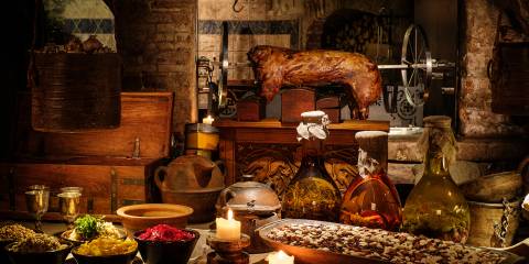 A rustic table set with a medieval feast
