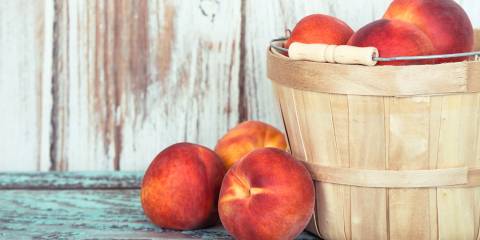 A basket of fresh organic peaches.