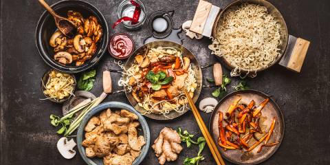 ingredients, pans, and tools for making a stir-fry