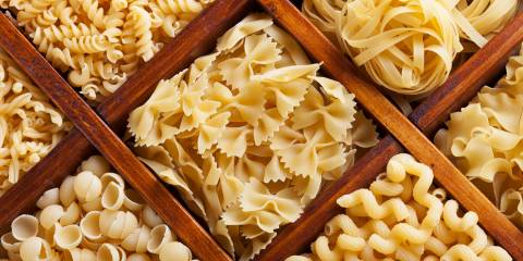 bowls of uncooked pasta in many shapes and designs