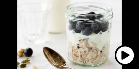a jar of oats, blueberries, and milk