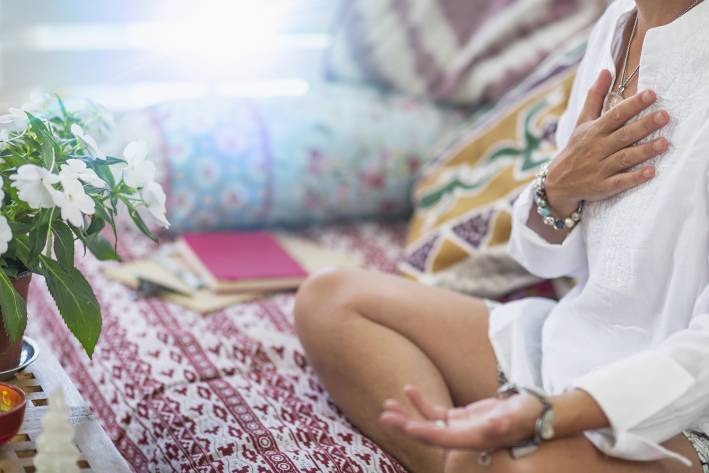 a woman wearing beads and meditating