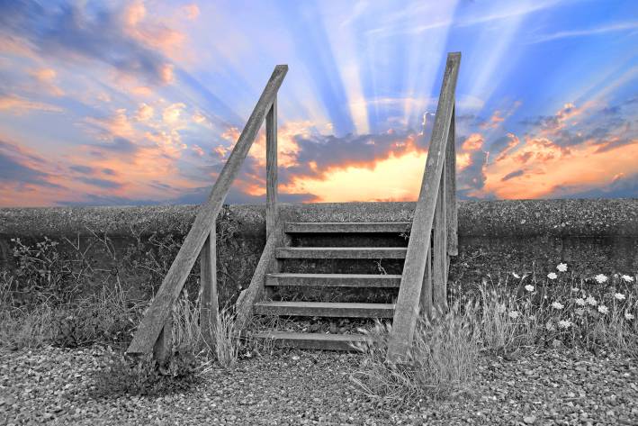 wooden steps leading up to a bright sky