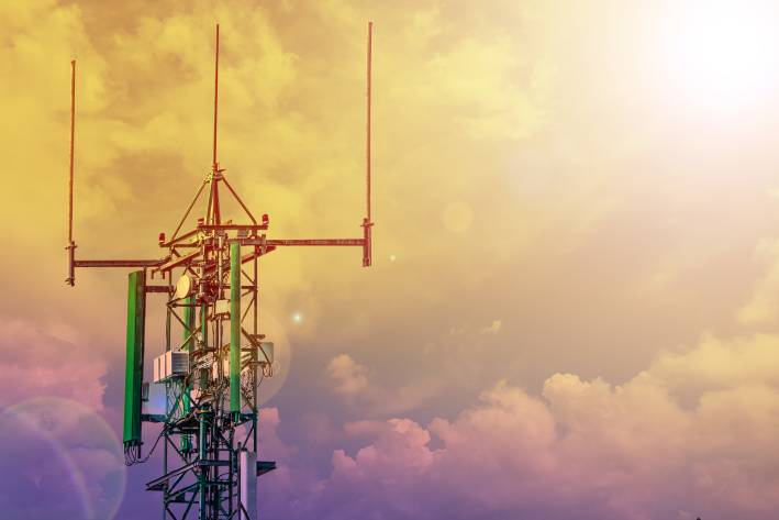 Communication tower or 4G 5G network telephone cellsite with cloudy sky during sunset. 