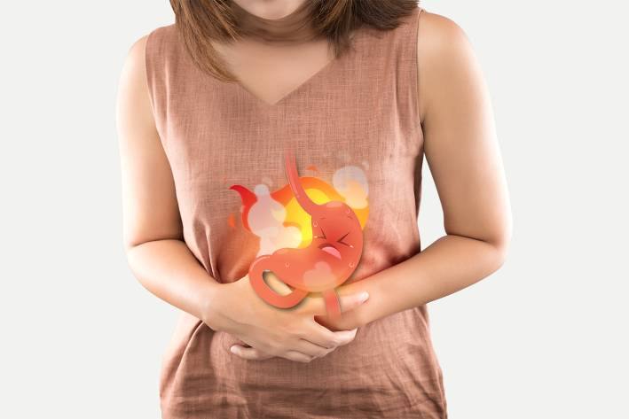 a woman suffering heartburn from an angry stomach