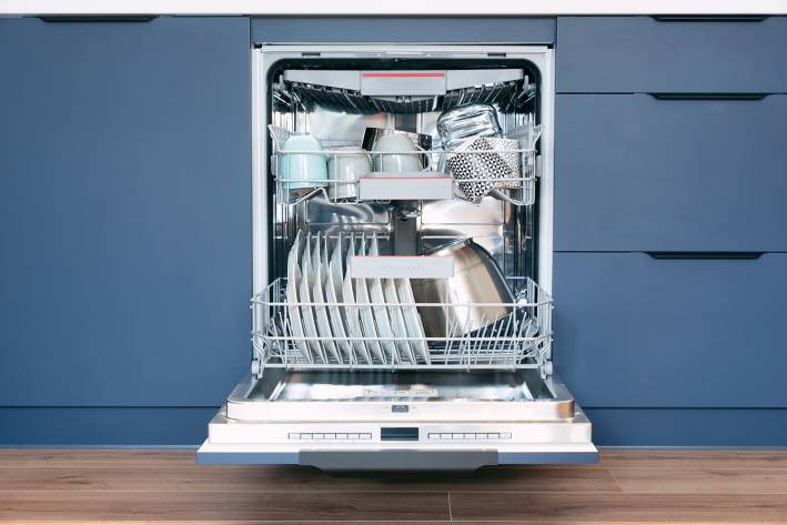 a dishwasher full of spotless bowls and plates