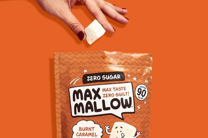 a woman snacking on a bag of marshmellows