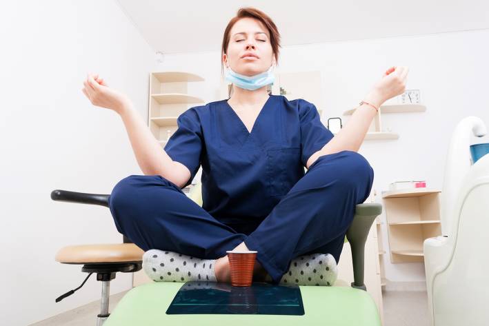 a young nurse meditating in the exam room