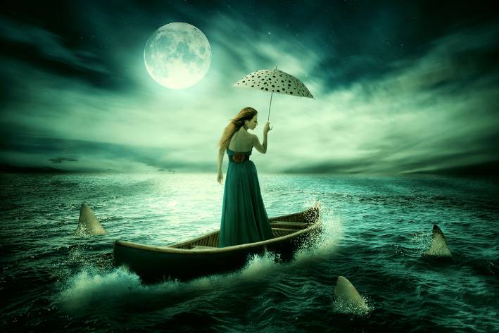 A woman drifting on a boat in stormy, shark-infested waters... but she's got great hair and a lovely umbrella.