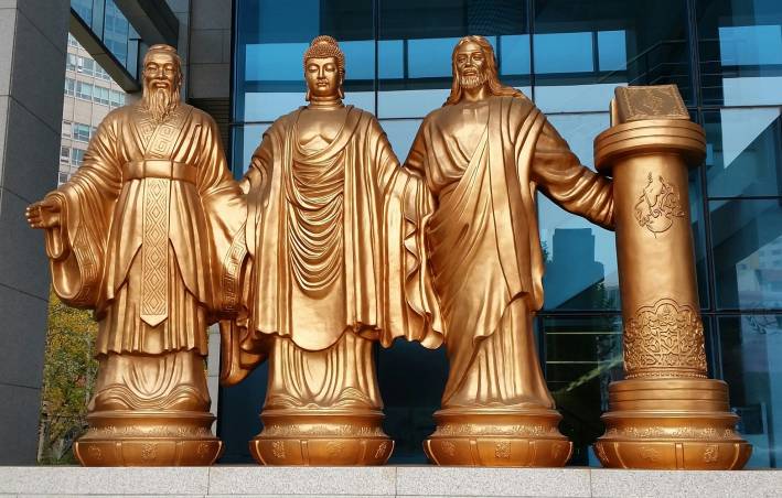 statues of spiritual leaders in a commercial district