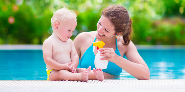 Mother Applying Sunscreen to Baby