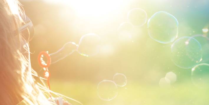 blowing bubbles in the summer sun
