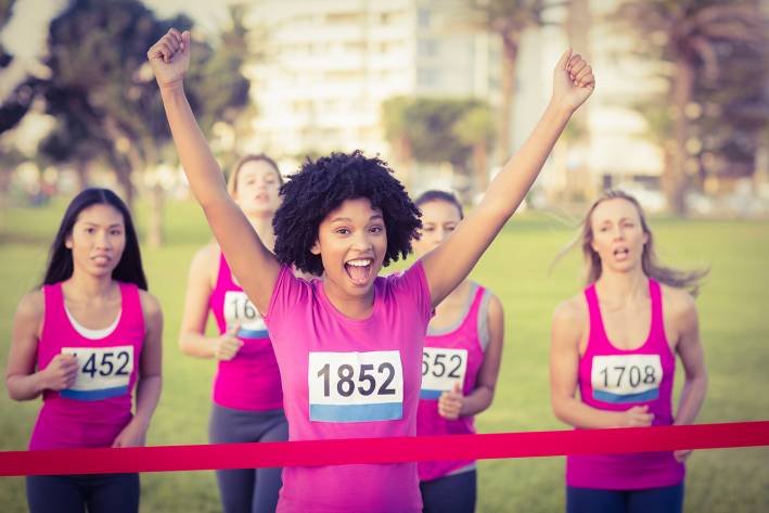 a young woman running against breast cancer