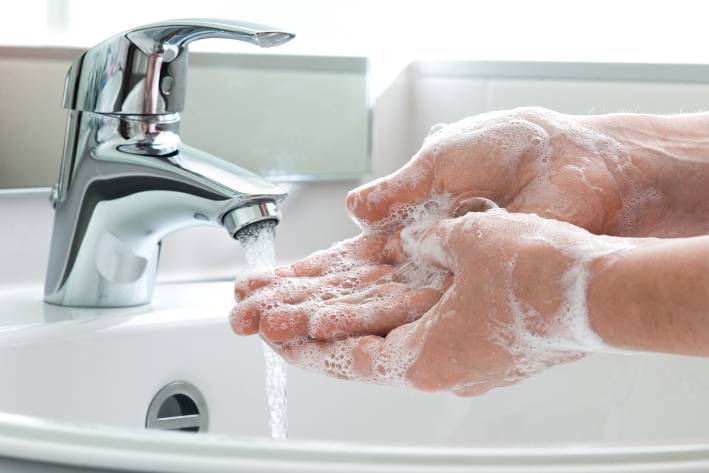a man washing his hands thoroughly