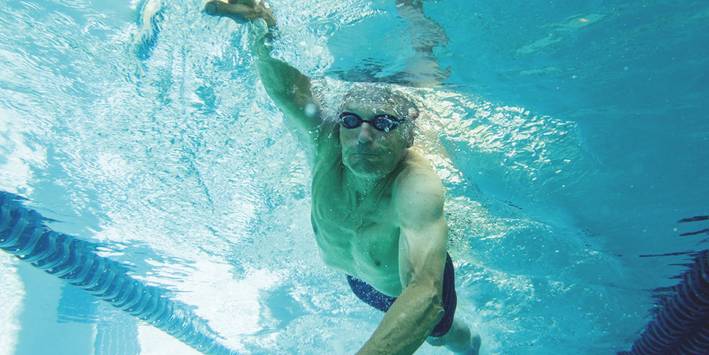 Man swimming to ease joint pain