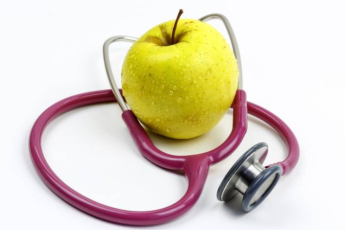 an apple wearing a stethoscope
