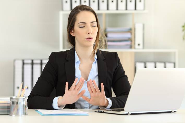 a woman in an office breathing to remain calm